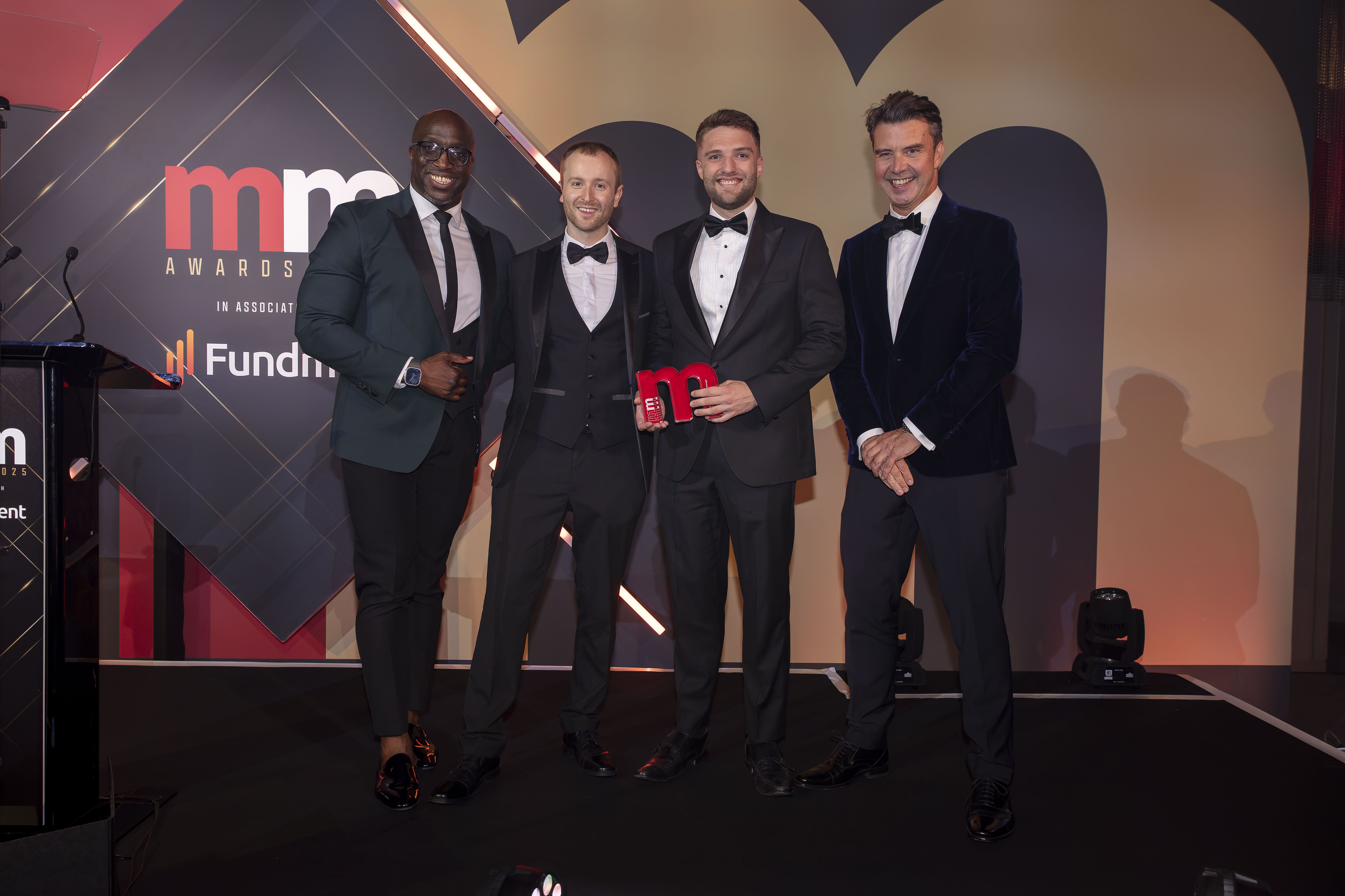 ebi's Ashley Owen and Thomas Ranft holding the Money Marketing Award